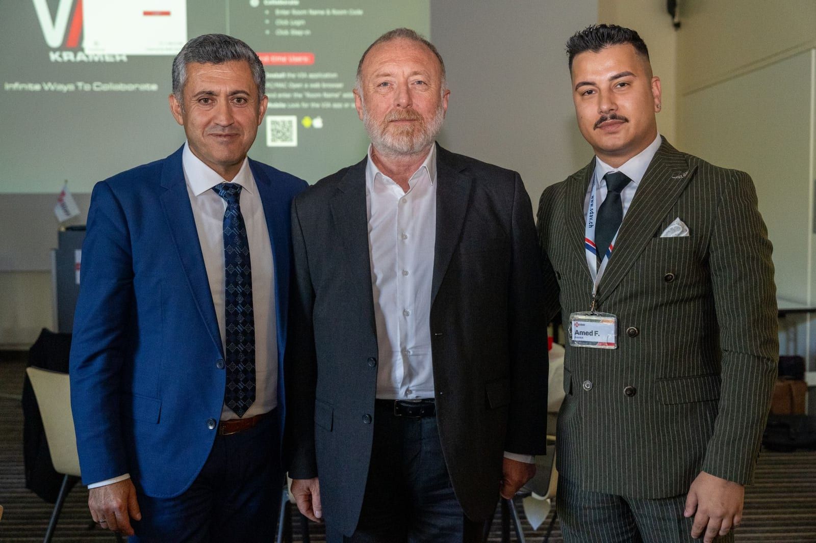 Amed F. Kavak, Head of Events of SDAV, with two participants in front of the projection screen.